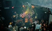 a group of people on stage in a dark room